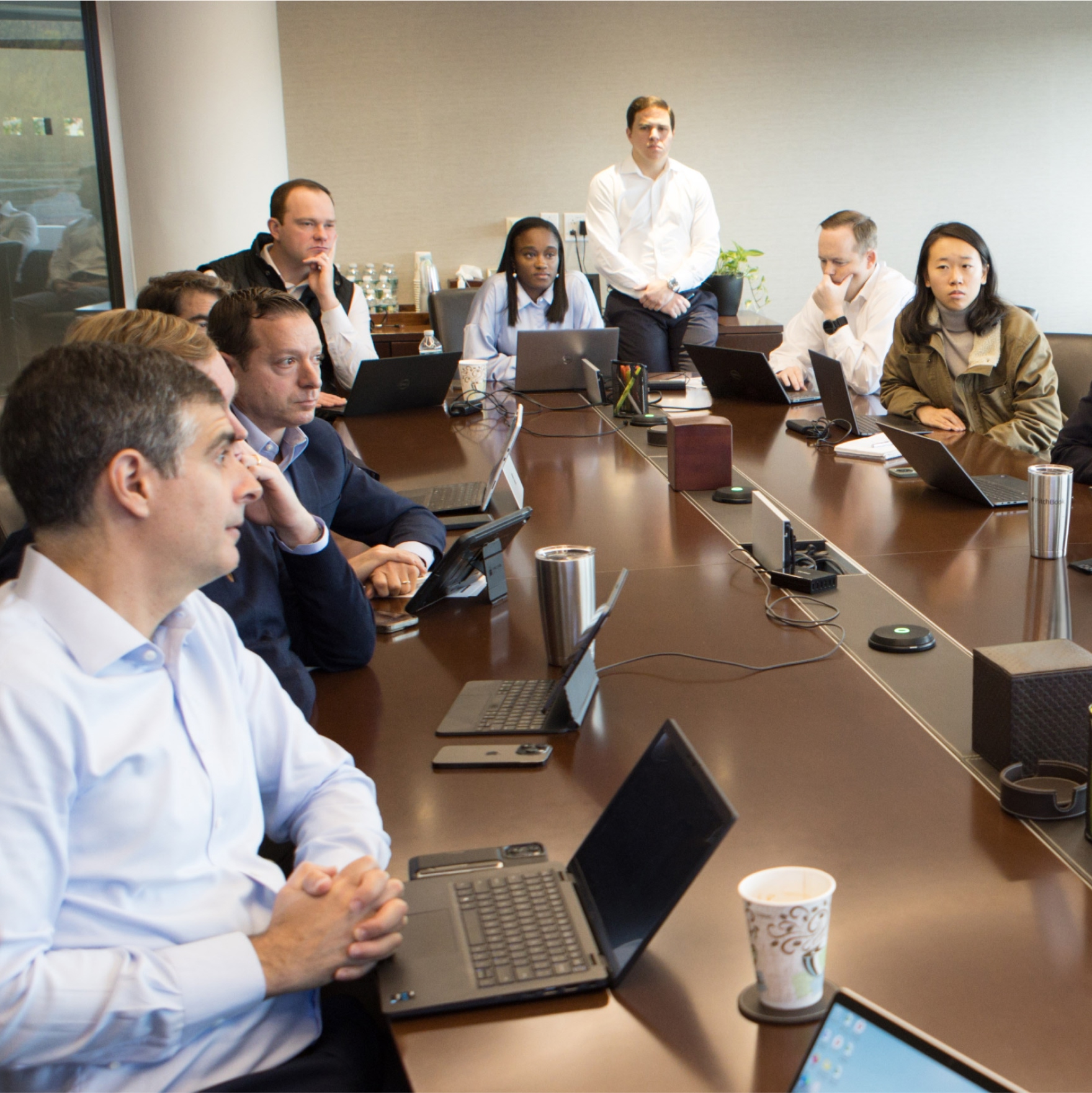 Team meeting with laptops in conference room